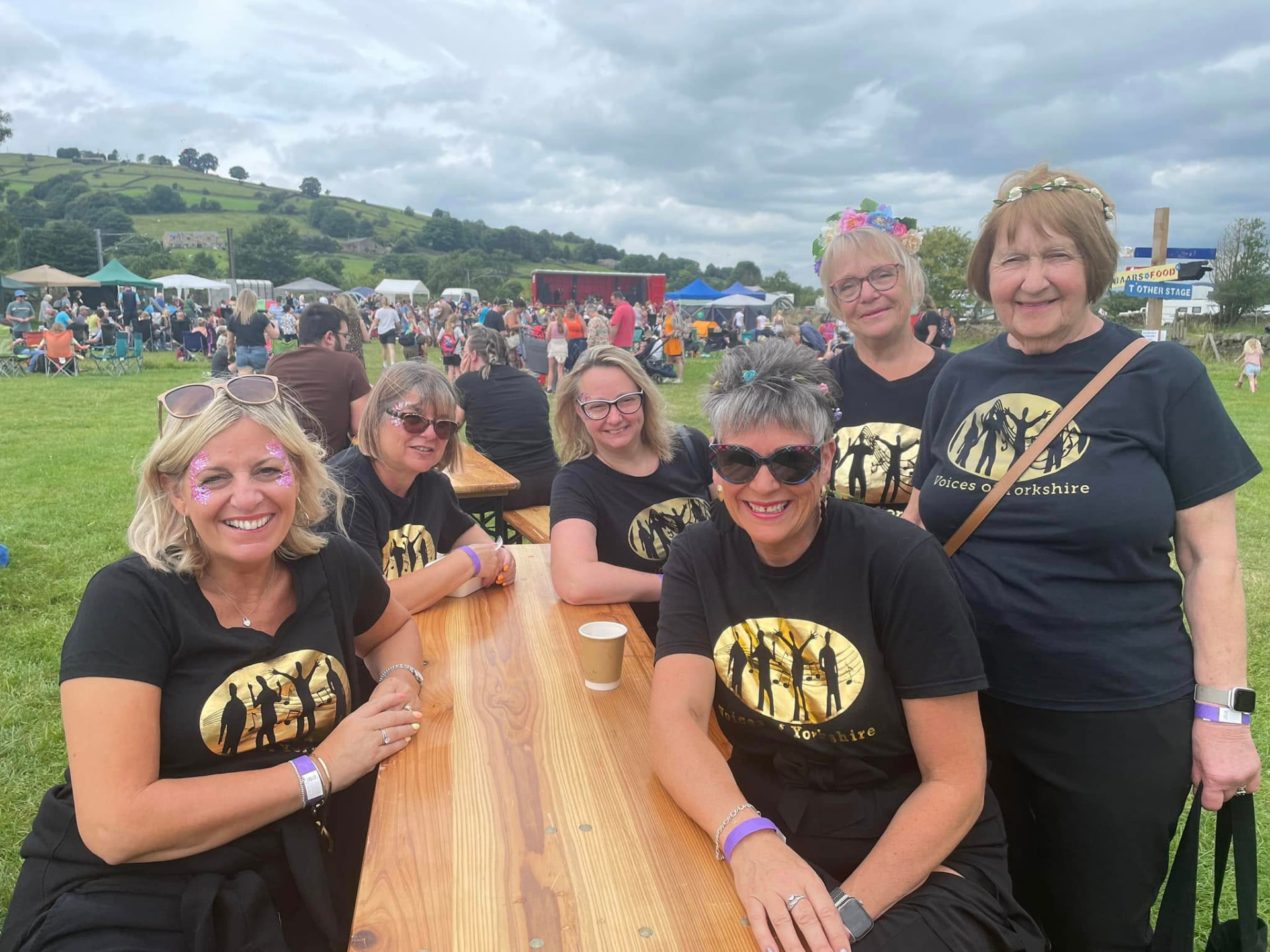 VOY members sitting together at a picnic table at an outdoor event