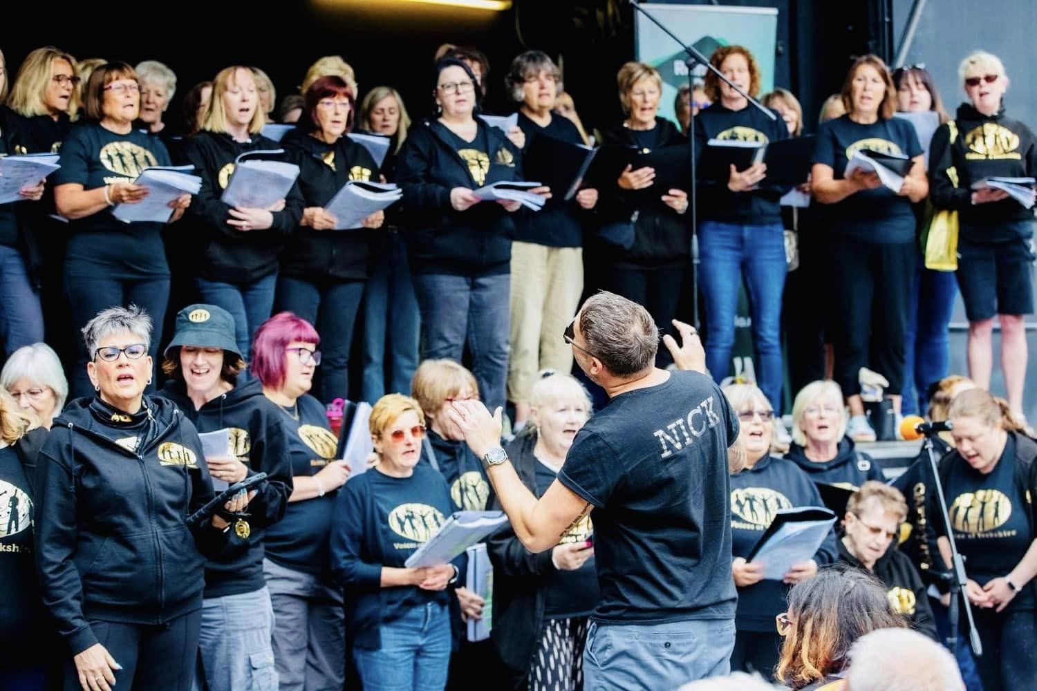 Nick conducting the choir at an outdoor performance