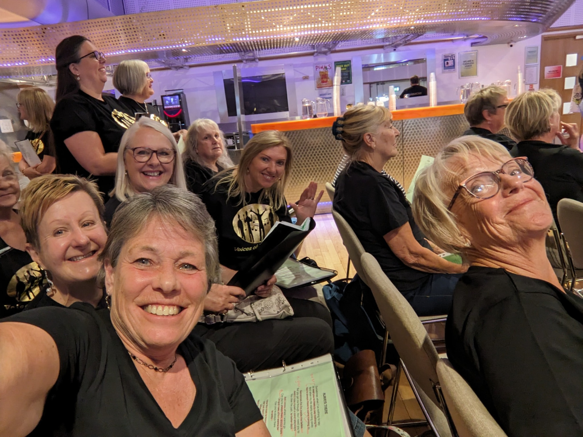 VOY members chatting in their seats before a rehearsal