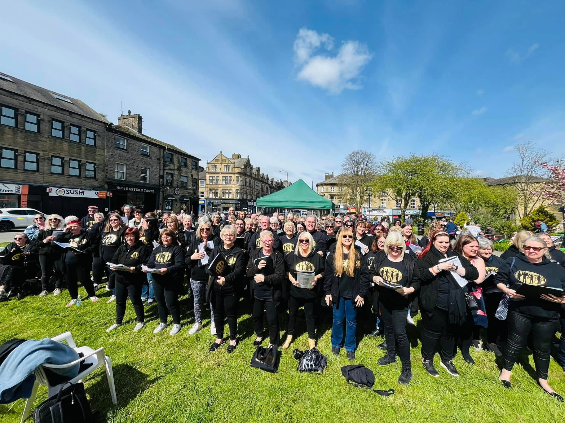 VOY members gathered outdoors in a Yorkshire town square on a sunny day
